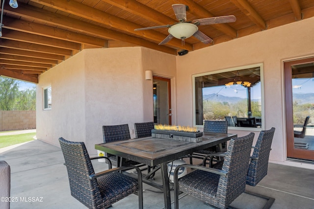 view of patio / terrace with ceiling fan, fence, and outdoor dining space