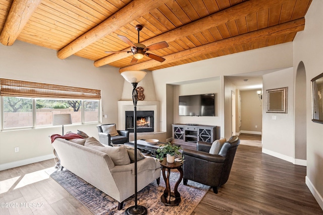 living room featuring a large fireplace, wooden ceiling, and baseboards