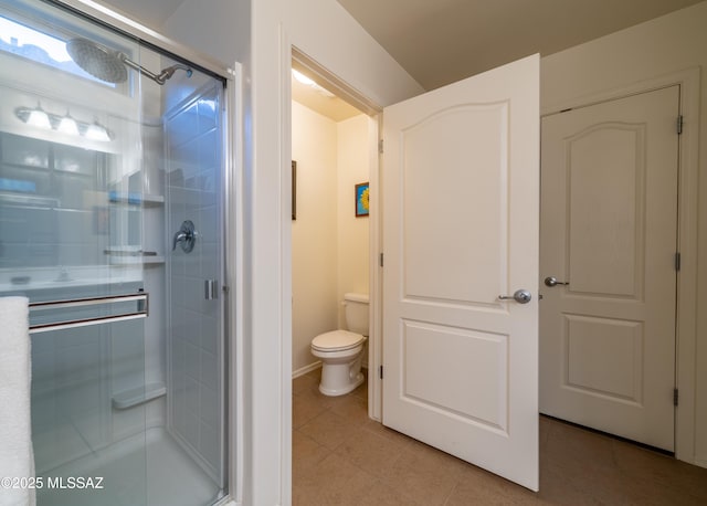 bathroom with toilet, a stall shower, and tile patterned flooring