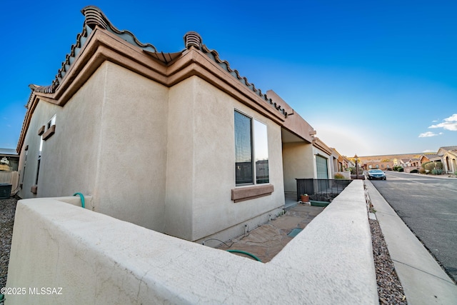 view of side of property with stucco siding