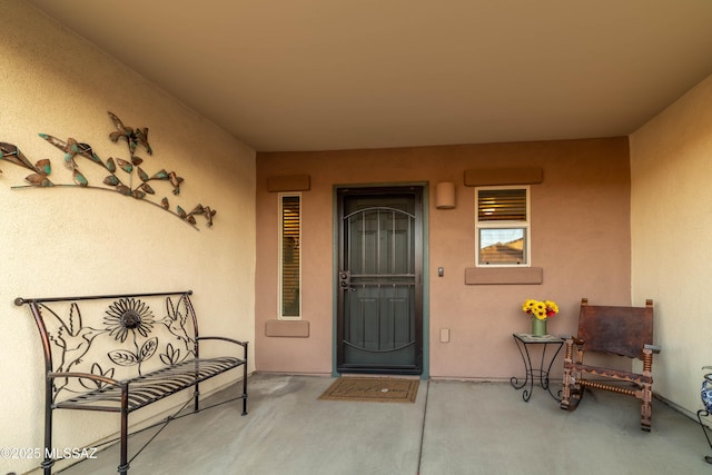 entrance to property featuring stucco siding