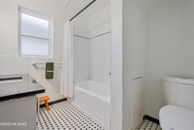 full bathroom featuring shower / tub combo with curtain and toilet