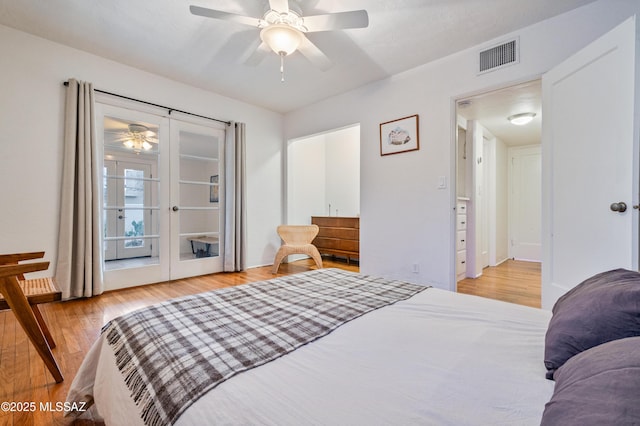 bedroom with light wood-style floors, visible vents, a ceiling fan, and french doors