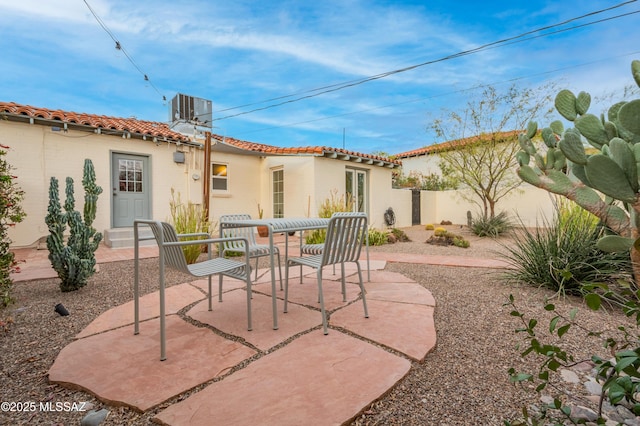 view of patio / terrace with central AC unit and fence