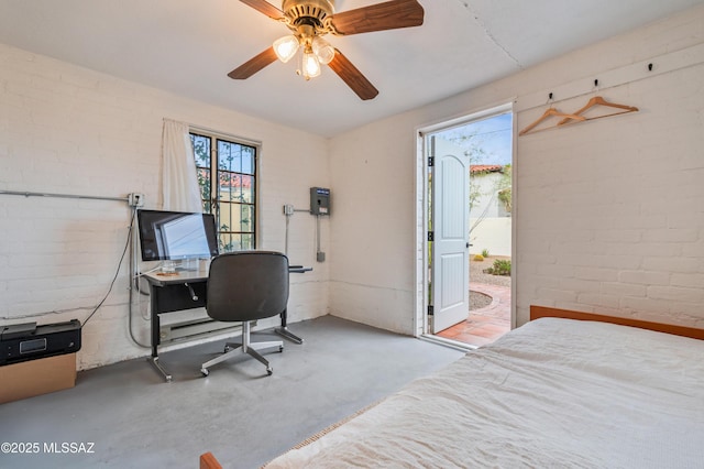 bedroom with brick wall, concrete floors, and a ceiling fan