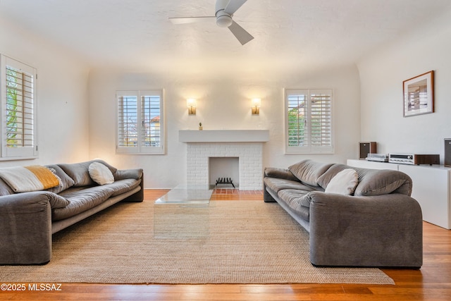 living room with plenty of natural light, a ceiling fan, and hardwood / wood-style floors