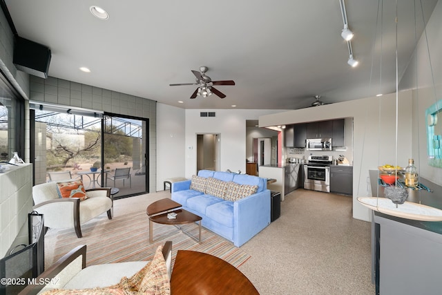 living area featuring rail lighting, recessed lighting, visible vents, and ceiling fan