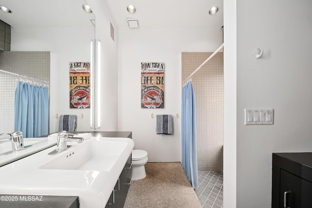 bathroom with vanity, toilet, recessed lighting, and tiled shower