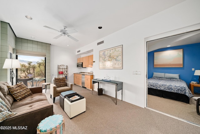 carpeted living room with visible vents, recessed lighting, and a ceiling fan