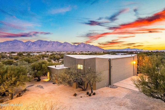 exterior space with stucco siding and a mountain view