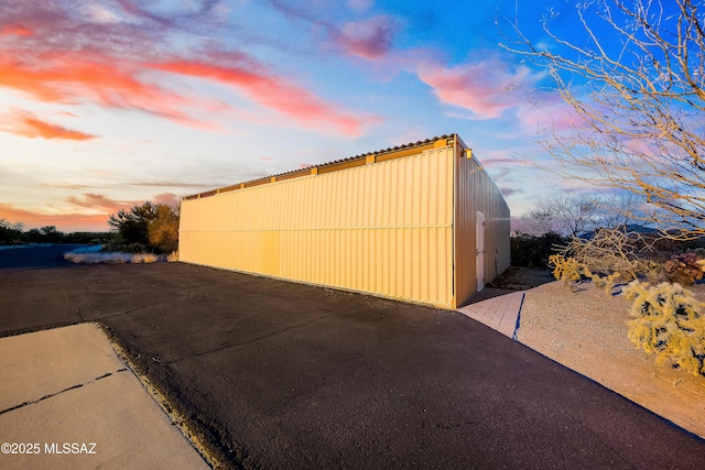 outdoor structure at dusk with an outdoor structure and a pole building