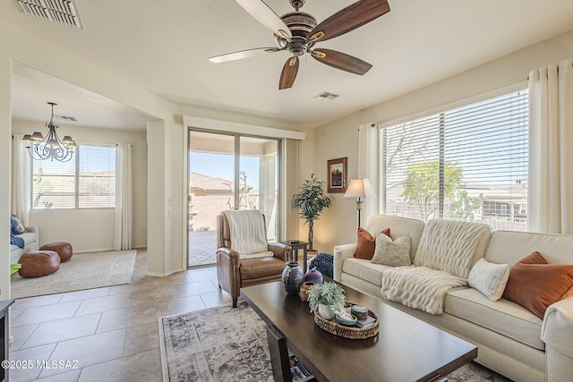 living room with light tile patterned flooring, visible vents, and a healthy amount of sunlight