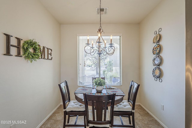 dining room with baseboards, visible vents, and a notable chandelier