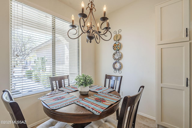 dining space featuring baseboards and a notable chandelier