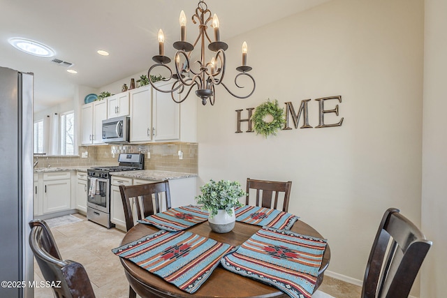 dining area featuring an inviting chandelier, baseboards, visible vents, and recessed lighting