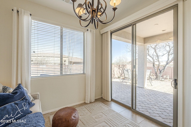 entryway with light tile patterned floors, baseboards, and an inviting chandelier