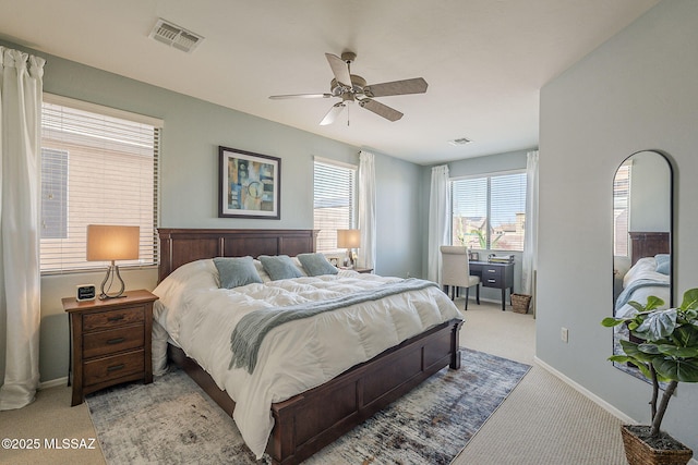 bedroom with carpet floors, visible vents, and baseboards