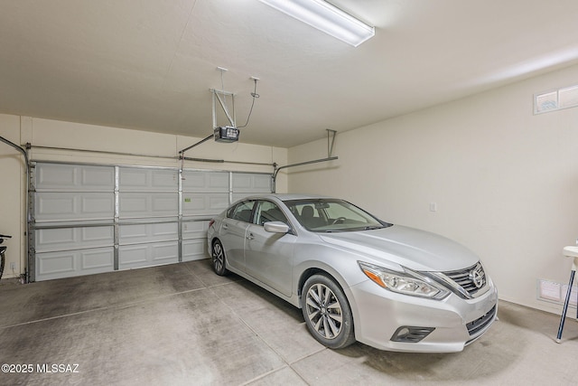 garage featuring visible vents and a garage door opener