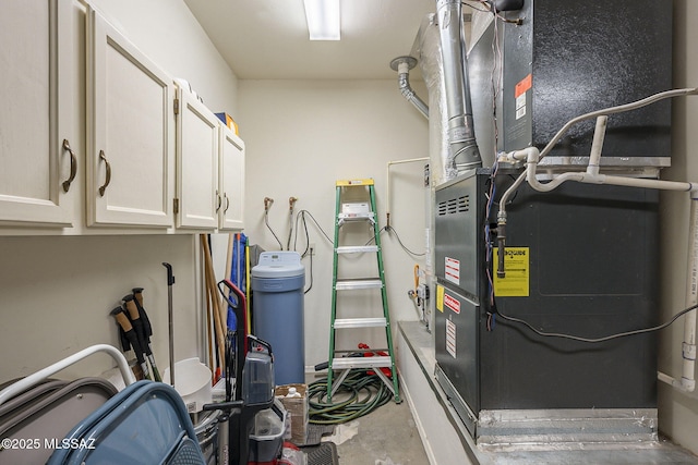 utility room featuring heating unit