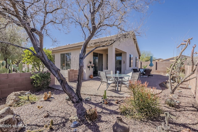 back of property with a patio area, a fenced backyard, and stucco siding