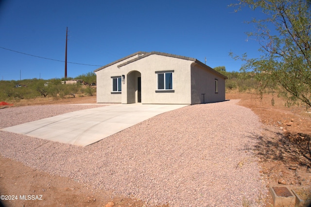 view of front of home with a tiled roof and stucco siding