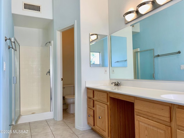 bathroom with tile patterned flooring, toilet, a sink, visible vents, and a stall shower