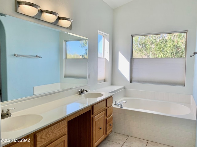 full bath with double vanity, a garden tub, tile patterned flooring, and a sink