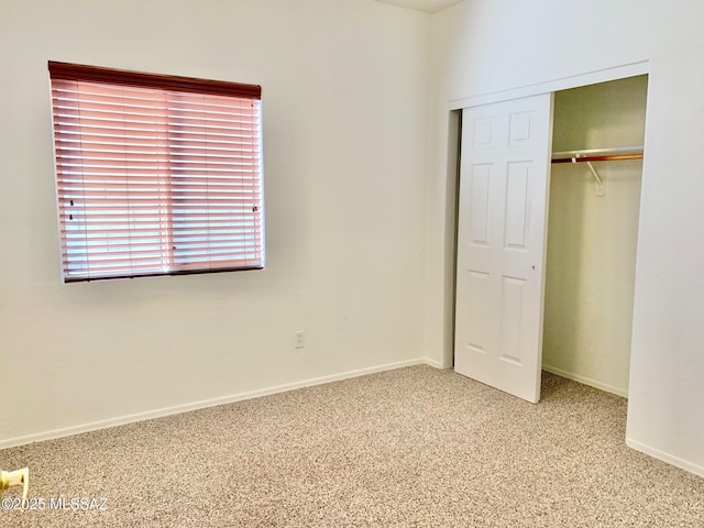 unfurnished bedroom featuring a closet, carpet flooring, and baseboards