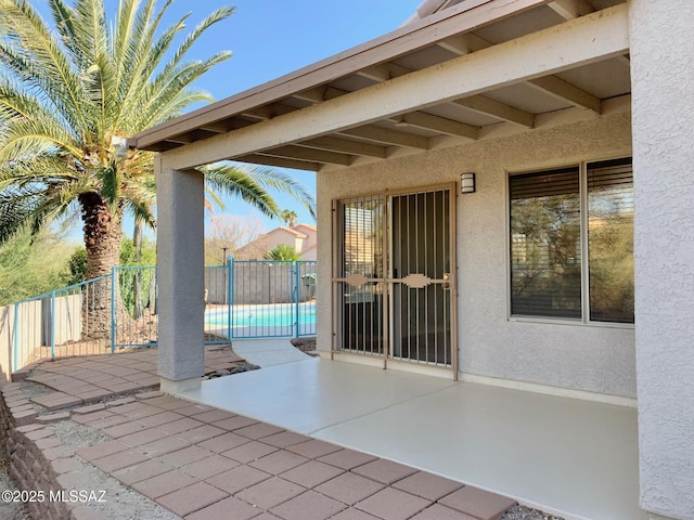 view of patio / terrace with fence and a fenced in pool