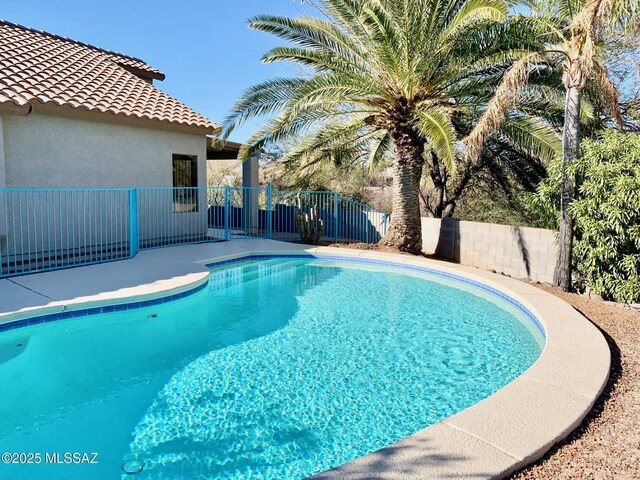 view of swimming pool featuring a fenced backyard and a fenced in pool