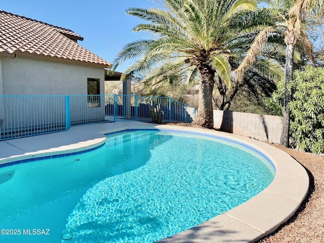 view of swimming pool featuring fence and a fenced in pool