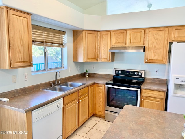 kitchen with white appliances, dark countertops, under cabinet range hood, a sink, and light tile patterned flooring