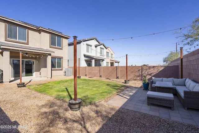 view of yard with outdoor lounge area, a patio, central air condition unit, and a fenced backyard