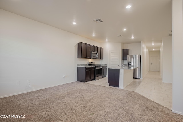 kitchen with visible vents, appliances with stainless steel finishes, open floor plan, and light colored carpet