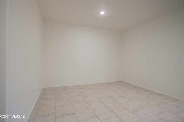 unfurnished room with recessed lighting and baseboards