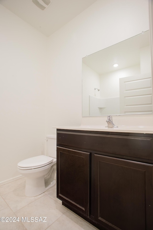 bathroom with visible vents, vanity, toilet, and tile patterned floors