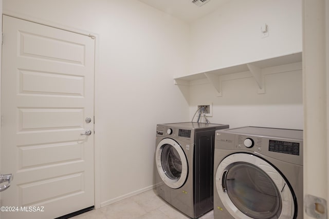 laundry room featuring baseboards, laundry area, visible vents, and washer and dryer