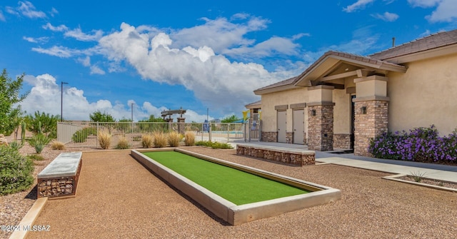 view of home's community featuring fence