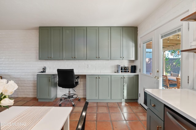 kitchen featuring built in desk and green cabinets