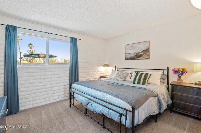 bedroom featuring carpet flooring and a textured ceiling