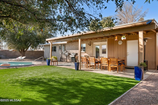 back of property featuring a patio, a yard, french doors, and fence