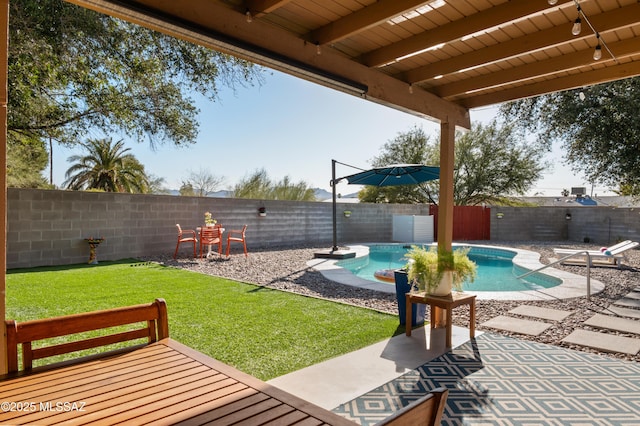 view of yard featuring a fenced in pool, a fenced backyard, and a patio area