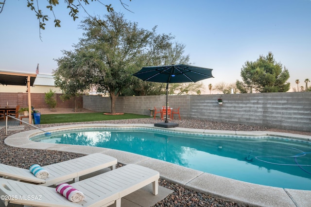 view of swimming pool with a fenced in pool and a fenced backyard