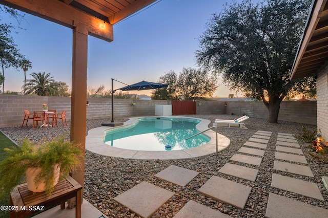 view of swimming pool with a fenced in pool, a fenced backyard, and a patio area