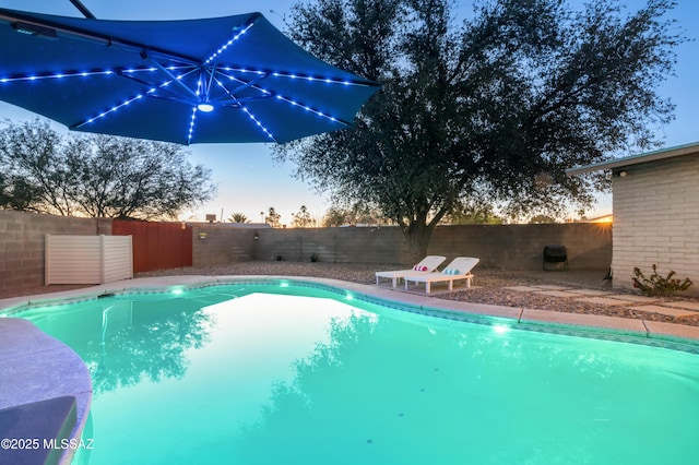 view of swimming pool featuring a fenced in pool and a fenced backyard