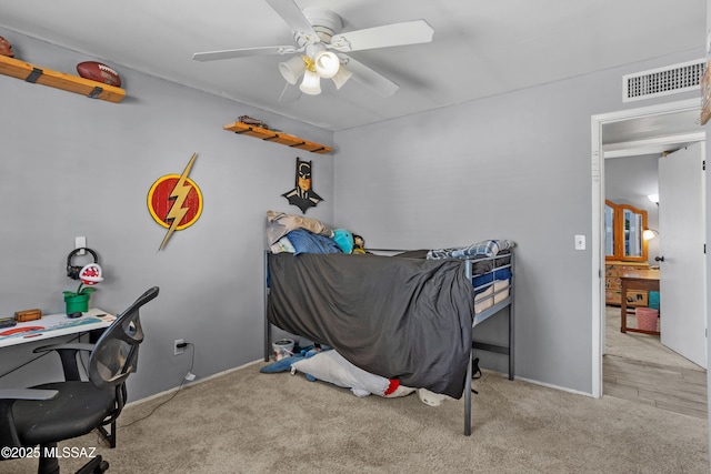 carpeted bedroom featuring visible vents and ceiling fan