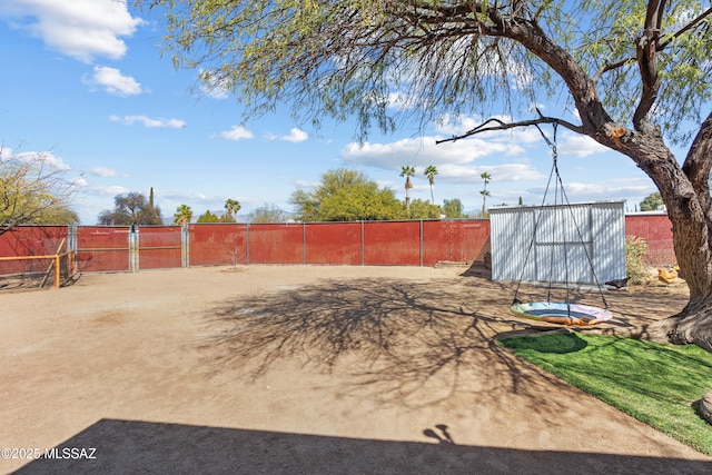 view of yard with a gate, an outbuilding, and fence