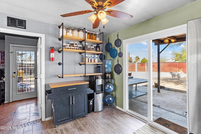 interior space with visible vents, plenty of natural light, light wood-style floors, and a ceiling fan