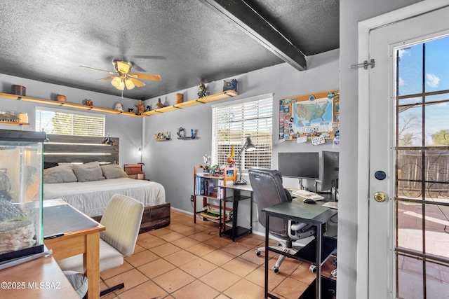 bedroom featuring light tile patterned floors, multiple windows, and a textured ceiling