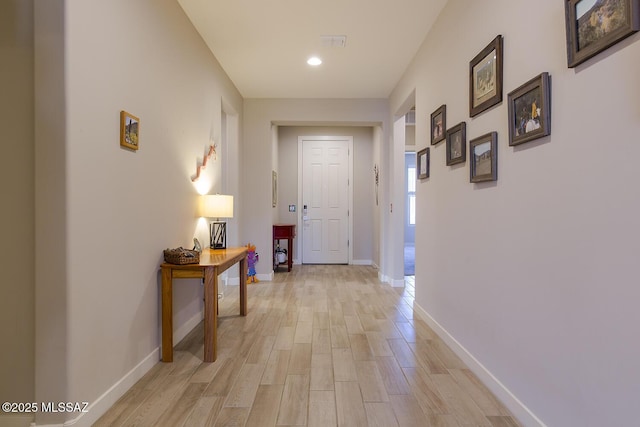 corridor with recessed lighting, light wood-type flooring, visible vents, and baseboards